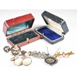 A c1900 9ct gold brooch (1.8g), three c1900 silver brooches one in the form of a key and heart