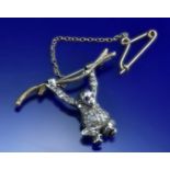 A 9ct gold and silver brooch in the form of a monkey set with diamonds and rubies, 6.7g, 3.5 x 2.4cm