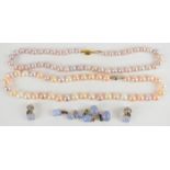 Two strings of cultured pearls, one with a 9k gold clasp and the other a silver clasp, together with