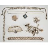 A silver charm bracelet with nine silver charms including dog, motorbike, fish, etc (46g), 900 grade