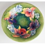 William Moorcroft pedestal bowl decorated in the Orchid / Spring Flowers pattern, signed to the base