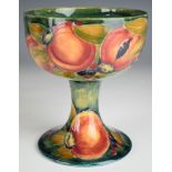 William Moorcroft chalice decorated in an early Pomegranate pattern on pale green ground with