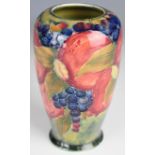 William Moorcroft vase decorated in the early Pomegranate pattern on pale green ground with open