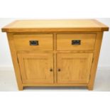 Modern oak sideboard with two drawers above cupboard doors with two shelves within, W105 x D45 x