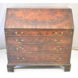 Georgian flame mahogany bureau, fitted four graduated long drawers, the main fall flap opening to