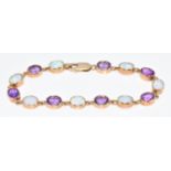 A 9ct gold bracelet set with amethysts and synthetic opals, 13.2g, 19.5cm