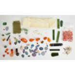 A collection of loose gemstones including black opal doublets, white opals, nephrite jade plaques,