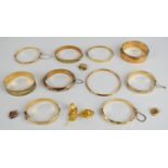 Ten gold plated bangles, one by L & Co, a rolled gold brooch and three heart shaped 9ct back and