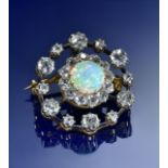 A c1900 15ct gold pendant/ brooch set with an opal cabochon of approximately 8mm surrounded by