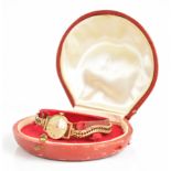 Omega 9ct gold ladies wristwatch with gold hands and hour markers, champagne dial and signed 17