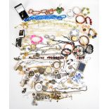 A collection of costume jewellery including rolled gold bangle, vintage brooches, a silver brooch,