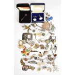 A collection of silver jewellery including eleven brooches, five pairs of cufflinks, two stick pins,