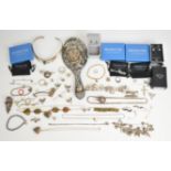 A collection of silver jewellery including nine pairs of earrings, two charm bracelets, locket,