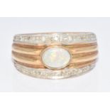 A 9ct gold ring set with an opal and diamonds, 8.3g, size O