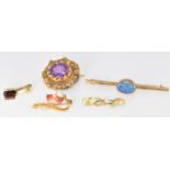 A 14k gold pendant set with an oval cut garnet (2.3g), two Edwardian brooches set with enamel and