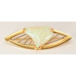 An 18ct gold brooch set with a white opal cabochon, 8.4g, 5.2cm