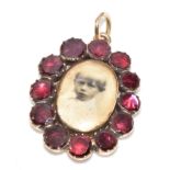 A c1850 Victorian pendant / locket set with foiled garnets, with locket compartment verso, 4.7g, 2.8