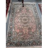 An Indian silk rug in pink with black details 200cm x 122cm