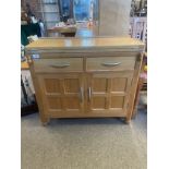 A Robert 'Mouseman' Thompson oak writing desk, two short drawers over two panel cupboard doors, with