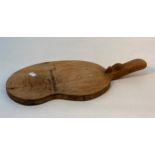 Robert Thompson, a Mouseman oak cheese board, kidney-shaped, with carved mouse signature to