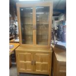 A Robert 'Mouseman' Thompson adzed oak drinks cabinet, with double door glazed cabinet above