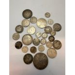 A collection of British pre-1920 silver coins, 18th Century and later, including a Queen Anne 'Vigo'