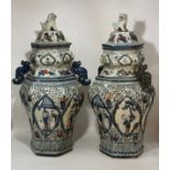 A pair of Chinese porcelain Hexagonal temple jars with kylin shaped handles and lids. An ear is