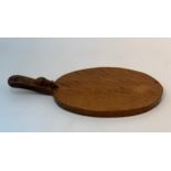 A Robert Mouseman Thompson adzed oak cheeseboard, the handle with carved mouse, 38cm wide