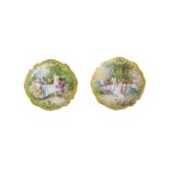 A LARGE PAIR OF 19TH CENTURY PORCELAIN CHARGER PLATES Painted interior scene, Victorian figures