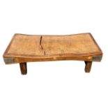AN EARLY 20TH CENTURY DECORATIVE LOW BUTCHERS BLOCK COFFEE TABLE Raised on four square legs.
