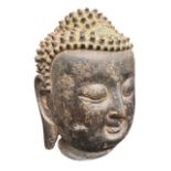 A 17TH CENTURY CHINESE MING DYNASTY BRONZE HEAD OF SHAKYAMUNI BUDDHA Having evidence of trace gilt