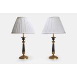 A pair of patinated and gilt-bronze candlestick lamps, early to mid-19th century, French,