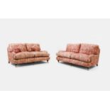 A pair of upholstered sofas in the manner of Howard and Sons, of recent manufacture,