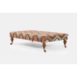A large kilim ottoman stool, of recent manufacture with 19th-century legs and castors,