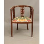 An Edwardian mahogany tub back open arm chair - with three pierced splats and a padded seat