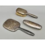 An early 20th century dressing-table set - comprising a hand mirror, hairbrush and clothes brush,