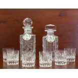 Two cut glass whisky decanters and a set of six small cut glass whisky tumblers - one decanter by