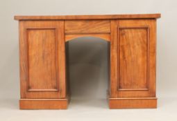 A mid-19th century mahogany dressing or writing table - the arched kneehole with a single drawer,