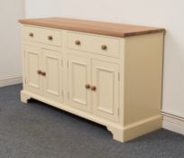 A Neptune light oak and cream-painted dresser base - maker's plaque inside one drawer, the light oak