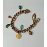 An antique 9ct rose gold charm bracelet - early 20th century, with a heart padlock clasp (stamped