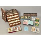 An early 20th century Chinese mahjong set - contained in a hardwood and bone inlay box with brass