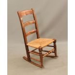 A child's beech, ash and walnut rocking chair - early 20th century, the ladder back over a rush
