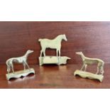 A pair of 19th century brass greyhound mantelpiece ornaments - the platform bases with shaped