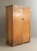 A 1940s Steel's of London carved oak wardrobe - with CC41 Utility Furniture stamp to back, the caddy