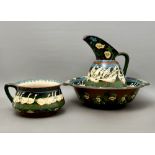 An Art Nouveau 'Intarsia' pitcher and basin - designed by Frederick Rhead, Wileman Foley, reg. no.