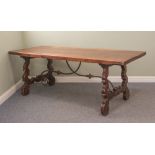 A 19th century Spanish walnut refectory-style dining table - the deep rectangular top raised on