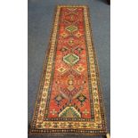 WASHED RED GROUND HAND WOVEN FULL WOOL PILE KAZAK RUNNER WITH MEDALLION DESIGN,