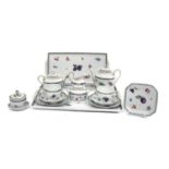 A Richard Ginori Porcelain Tête-à-Tête, decorated with fruit and flower sprigs, under blue feather