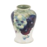 William Moorcroft (1872-1945): A Pansy Pattern Vase, circa 1913-16, in purple, yellow and green on a