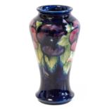 William Moorcroft (1872-1945): A Pansy Pattern Vase, circa 1930s, on a dark blue ground, impressed